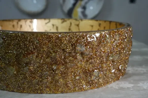 Handcrafted gold leaf marble washbasin with textured glitter exterior from Majestics Group.