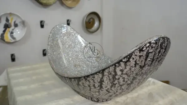 Grand 85cm Pinnache crescent-shaped artisan washbasin with shimmering silver crystal interior and dark textured exterior by Majestics Group.