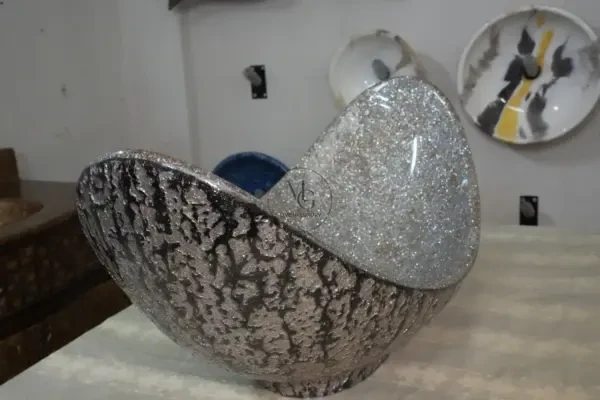 Grand 85cm Pinnache crescent-shaped artisan washbasin with shimmering silver crystal interior and dark textured exterior by Majestics Group.